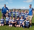 Rochdale Mayfield Mustangs under 9s team in their new kit, with coaches Simon Howe and Mayfield first team star player, David Wood