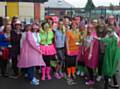 Woodland teacher Paige Roebuck (centre) prepares to put staff and children through their paces for the Macmillan’s ‘Dress up and dance’ day