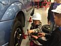 Visitors get to grips with changing a car tyre at Hopwood Hall College’s Summer Fun Day