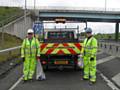 Workers collecting litter on the M60/M62 smart motorway scheme