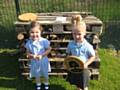 Children form St John with St Michael CE Primary School with the Bug Hotel and their Gold Award