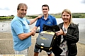 Robert Dunn and daughter Emma thank Joe Ready, with the defibrillator