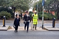 A lollipop man helps children cross busy Whitworth Road