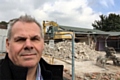 Councillor Richard Farnell watches as builders demolish Kirkholt Workingmen's Club