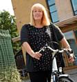 Sarah Riley, Community Development Coordinator at Great Places Housing Group using her eBike