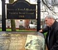 Council Leader Richard Farnell inspects the existing information board at the Quaker Burial Ground