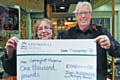 John Alexander presents a cheque for £1,000 to Springhill Hospice’s Barbara Lloyd