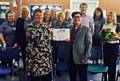 The Castleton GP Practice receive their Pride in Practice Gold Award, behind left to right:  Amber Clarke, Barbara Mitchell, Angela Cockcroft, Karen Pearson, Hilary Cardona, Debbie McMillan, Dr Edwards, Marie Chadderton and Jane Gaunt. Accepting the award is Dr Schofield (front left) from Pride In Practice Manager, Laurence Webb