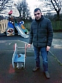 Paul Ellison pointing to the human excrement left on a children's ride in Norden