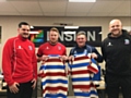 Analyst Steve Wordsworth, first team players Chris Riley and Jono Smith and head coach Alan Kilshaw show off the Ensign logo on the 2017 home shirt