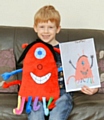 Thomas Mitchell with his drawing of a dust mite 