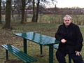 Councillor Farnell takes a seat at one of the new disabled-friendly benches in Balderstone Park