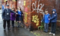 Councillor Billy Sheerin potining out graffiti with Jessica Slack, Sophie White, Sam Dyson and Thomas Grogan