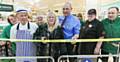 Rochdale Morrisons loyal shopper Jackie Hirst cuts the ribbon with store manager Peter Matthews and staff