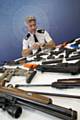 GMP Assistant Chief Constable John O’Hare with some of the firearms and ammunition