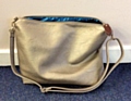 Have you found or seen a brown leather bag with a shoulder strap or a metallic/gold shopping bag, like the one in the photo