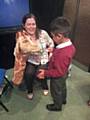 Kentmere Academy pupil learns to clean a Harold the Giraffes teeth 