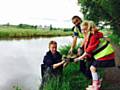 Children from St Edwards Church of England Primary School with volunteers from the Canal & River Trust planting Luronium in Rochdale Canal