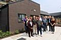 RBH employees, local residents and community representatives outside the new homes at Lower Falinge