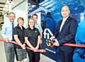 Ian Pugh of Fix Auto UK cuts the ribbon declaring the latest Fix Auto Fix & Go express repair facility open for business with owners (from left) Phil and Wendy Ewbank with Managing Director Michelle Walker and VDA and Business Development Manager Lee Ewbank