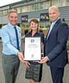 Ian Pugh, head of Fix Auto UK, presents Phil and Wendy Ewbank, owners of Fix Auto Rochdale, with their plaque after becoming the latest members of the network’s 10th Anniversary Club