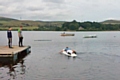 Craig Moodie paddling to the stranded boy’s aid on a windsurfing board