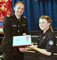 Cadet Chloe Brown receives her Cadet of the Year certificate from Assistant Chief Fire Officer Dave Russel