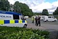 Police supervise the departure of travellers from Tesco car park