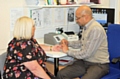 Dr Gupta from Pennine Surgery, Littleborough with patient having a fingerprick blood test to tell whether she needs antibiotics to treat her symptoms