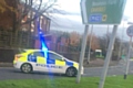 A police car blocks access to Albert Royds Street from the roundabout