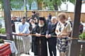 Dianu Sfrijan (2nd right) cuts the ribbon has the centre is formally opened 