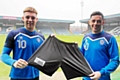 Callum Camps and Ian Henderson show the Prostate Cancer UK logo on Rochdale shorts