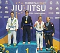 Sophie Cox on the podium after winning gold, European Masters blue belt lightweight