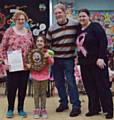 Heidi Mooney receiving her trophy from Denise’s husband Michael Webb with leaders Katie Haigh and Diana Kilduff