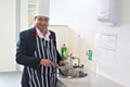 Councillor Ahmed gets ready to cook up a special thank you to council staff