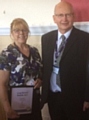 Chris Verity, Health Visitor, receiving her Long Service Award certificate from John Schofield, Chairman