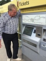 Councillor Butterworth at the broken ticket machine at Newhey