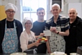 Brad Gartland (centre) and Pete Duffy (far right) from the SG6 Foundation presenting a cheque to participants of Kitchen Kapers