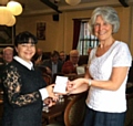 Judith Brown (right) presents a cheque to the local British Heart Foundation manager Anita Lord