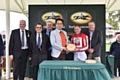 Richard Farnell and representatives of Hanson Springs present jockey Paul Hanagan with a prize