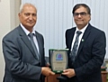 Ghulam Rasul Shahzad was presented with the Plaque of Recognition by Amjad Malik