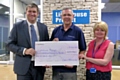 Councillor Chris Furlong presents staff from the Lighthouse Project Middleton with a cheque for £625