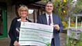 Councillor Chris Furlong presenting Julie Perry, Corporate Service Manager at Springhill Hospice with the cheque