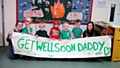 Zach and his keyperson Beth (both far right) hold the sign Zach and his friends painted for fireman Alex Green