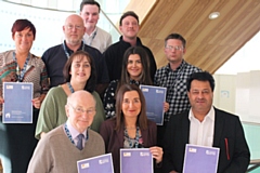 Councillor Iftikhar Ahmed, cabinet member for adult care, and his assistant, Councillor Billy Sheerin, congratulate members of the adult care home improvements team on their success