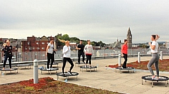 Rochdale Borough Council staff take part in a boogie bounce class on the roof of Number One Riverside