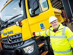 Councillor Neil Emmott with one of the gritters at the council’s Princess Street depot in Rochdale