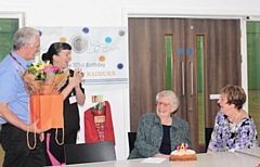 Gladys Radburn being presented with her presents and cake