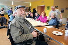 Clifford Dodgson in his new wheelchair at the Sandbag Cafe