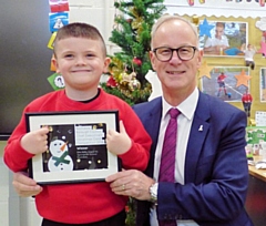 Rochdale Borough Council chief executive Steve Rumbelow meets Ellis Kelly at Springside Primary School in Rochdale, presenting him with a framed version of his design